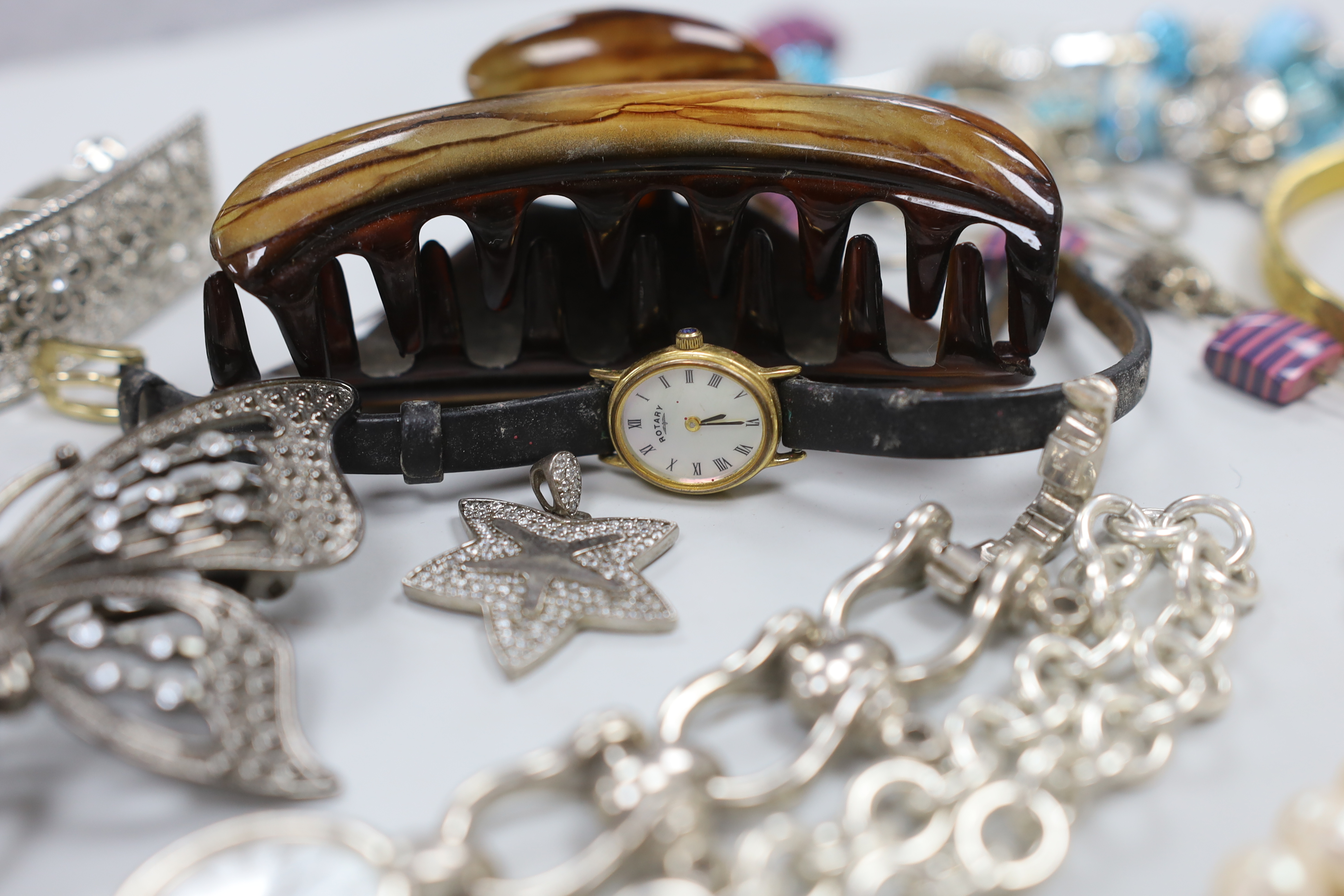 Four assorted 9ct gold and gem set rings, gross weight 6.3 grams, a 925 and rose quartz bracelet, a silver bracelet watch, a silver horseshoe and riding crop brooch and other jewellery including costume.